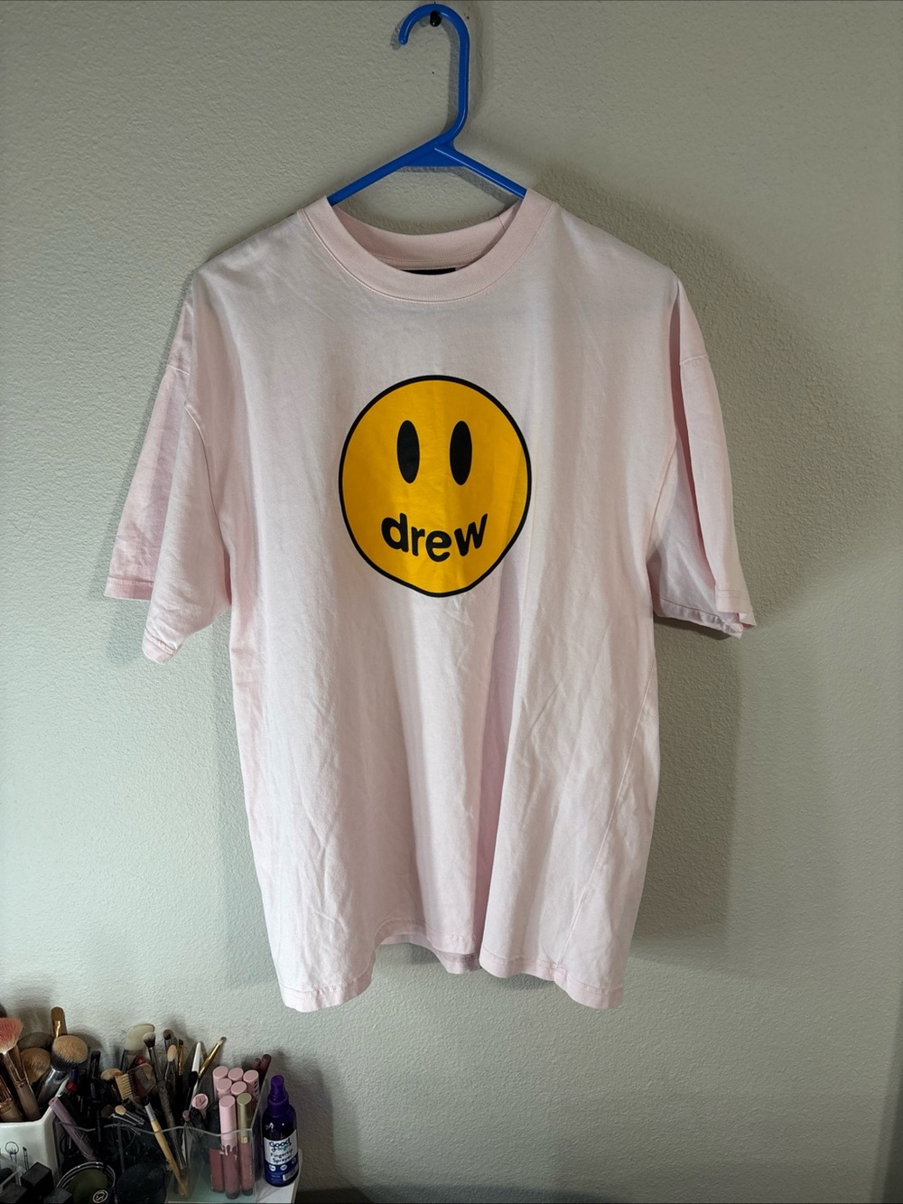 drew house light pink tee with yellow smiley
